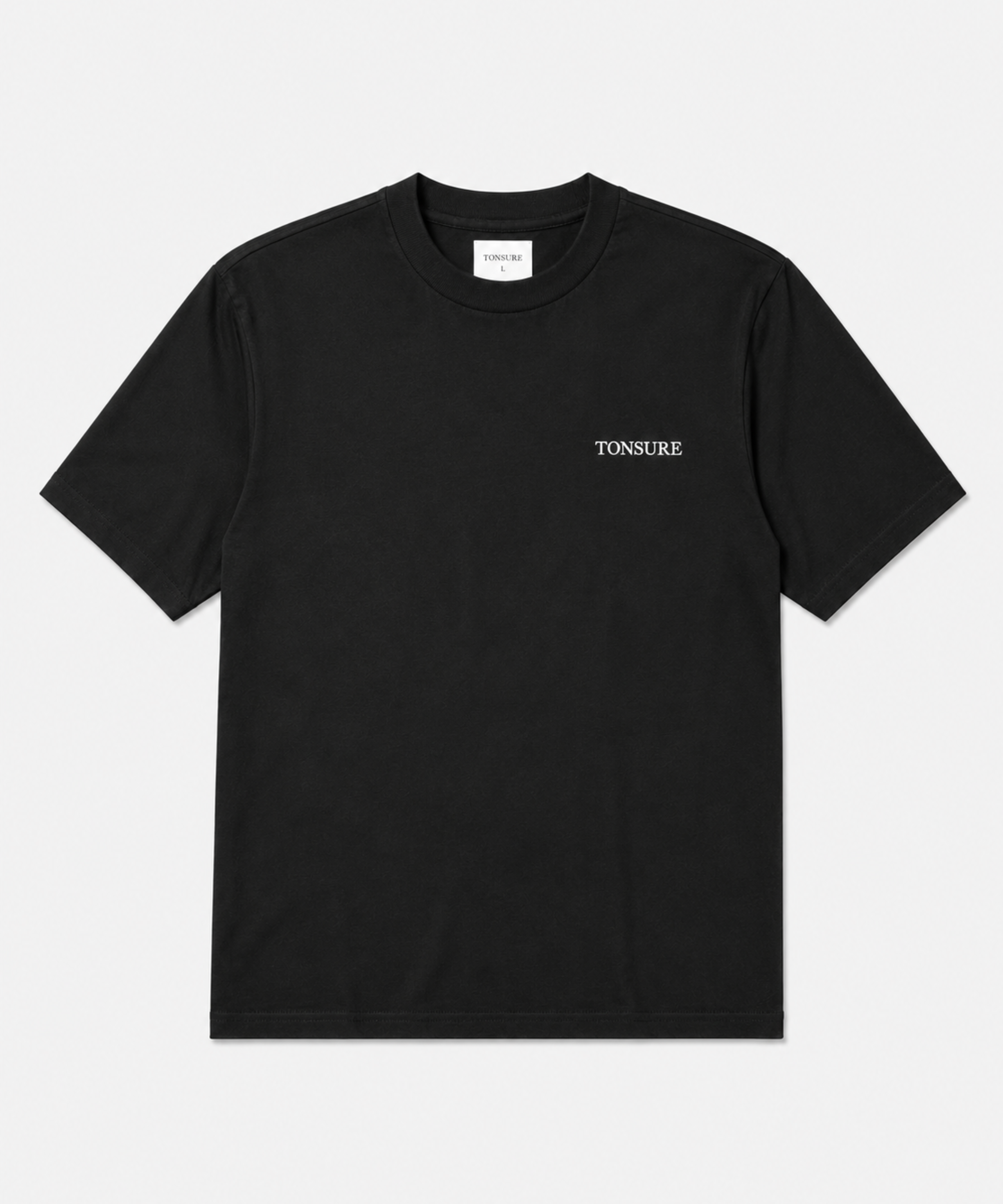 Sort t-shirt til mænd i bæredygtigt bomuld fra danske herretøjsbrand Tonsure. Ryggen er prydet med Teddy Copenhagen print i stor størrelse.